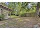 Wide-open backyard featuring a covered patio, grassy areas and a wooden fence at 109 Salem Ct, Summerville, SC 29486