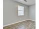 A serene bedroom with wood-look flooring and a bright window, offering simple elegance at 109 Salem Ct, Summerville, SC 29486