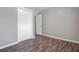 A bedroom with wood-look flooring, a double closet, and a light gray color scheme at 109 Salem Ct, Summerville, SC 29486