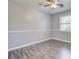 Neutral bedroom with a ceiling fan, wood-look flooring, and a large window, offering a calm space at 109 Salem Ct, Summerville, SC 29486