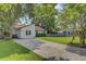 Quaint one-story home with a long driveway, complemented by a lush green lawn and mature trees at 109 Salem Ct, Summerville, SC 29486