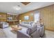 Inviting living room featuring wood paneling, comfortable seating, and ample natural light at 109 Salem Ct, Summerville, SC 29486