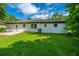 Spacious backyard with a well-maintained lawn and a white brick home at 114 Bailey Dr, Summerville, SC 29485