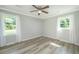 Bedroom with light wood flooring, two windows with curtains, and neutral walls at 114 Bailey Dr, Summerville, SC 29485