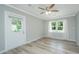 Bright bedroom featuring hardwood floors, a ceiling fan, and two large windows for natural light at 114 Bailey Dr, Summerville, SC 29485