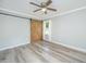 Light and airy bedroom features a sliding barn door and wood-look floors at 114 Bailey Dr, Summerville, SC 29485