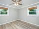 Bedroom with wood-look flooring and two windows with bamboo shades at 114 Bailey Dr, Summerville, SC 29485