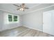 Clean bedroom featuring hardwood floors, a ceiling fan, and a large window for natural light at 114 Bailey Dr, Summerville, SC 29485