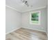 Bright bedroom featuring light wood flooring, crown molding, neutral walls, and natural light at 114 Bailey Dr, Summerville, SC 29485