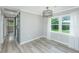 Bright dining room with stylish flooring, large windows, modern light fixture, and a gray barn door at 114 Bailey Dr, Summerville, SC 29485