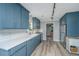 Modern kitchen featuring blue cabinets, white countertops, stainless steel appliances, and updated flooring at 114 Bailey Dr, Summerville, SC 29485