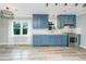 Open kitchen boasts stylish blue cabinets, stainless steel appliances, and ample counter space at 114 Bailey Dr, Summerville, SC 29485