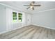 Bright living room with new flooring, a ceiling fan, and a large window overlooking the front yard at 114 Bailey Dr, Summerville, SC 29485