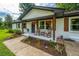Inviting front porch with rocking chairs, decorative hanging baskets, and fresh landscaping at 114 Bailey Dr, Summerville, SC 29485