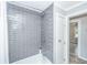 Updated shower with gray subway tile, chrome fixtures and a white shower curtain at 114 Bailey Dr, Summerville, SC 29485