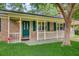 Inviting front porch with brick facade, teal door, and white railing at 114 Stewart St, Goose Creek, SC 29445