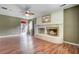 Spacious living room features a brick fireplace, wood floors, and bright natural light at 114 Stewart St, Goose Creek, SC 29445