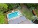 Aerial view showcases the backyard pool, deck, lush landscaping, and charming home at 1145 Bellwood Rd, Charleston, SC 29412