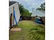 Backyard with a wooden surfboard next to a blue surfboard, outdoor shower, and a wooden fence at 1145 Bellwood Rd, Charleston, SC 29412