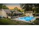 Backyard with inviting pool, lounge seating, tropical plants, and outdoor entertaining spaces at 1145 Bellwood Rd, Charleston, SC 29412