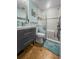 Stylish bathroom features walk-in shower, slate-colored vanity, and cool light-green paint at 1145 Bellwood Rd, Charleston, SC 29412