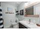 This bathroom includes rustic shelving and a wooden mirror to accent the light blue walls at 1145 Bellwood Rd, Charleston, SC 29412