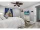 Comfortable bedroom with fan, TV, and natural light from window with blue curtains at 1145 Bellwood Rd, Charleston, SC 29412