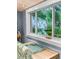 Sunlit dining area with a window showcasing lush tropical foliage bringing the outdoors inside at 1145 Bellwood Rd, Charleston, SC 29412