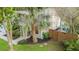 Aerial view of the home's entrance framed by a mature palm tree and backyard featuring seating around the pool at 1145 Bellwood Rd, Charleston, SC 29412