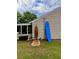 Outdoor shower next to surfboard storage is conveniently located near enclosed porch on lush green lawn at 1145 Bellwood Rd, Charleston, SC 29412