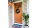 Charming front door with wreath, welcome mat, sidelight window, and exterior light fixture at 1145 Bellwood Rd, Charleston, SC 29412