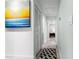 Inviting hallway featuring artwork, white doors, and a decorative rug, creating a welcoming transition at 1145 Bellwood Rd, Charleston, SC 29412