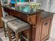 Close up of kitchen island with granite top, decorative corbels, and cushioned seating adding comfort at 1145 Bellwood Rd, Charleston, SC 29412