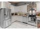 Bright kitchen featuring white cabinets, stainless steel appliances, and a patterned tile floor for added style at 1145 Bellwood Rd, Charleston, SC 29412