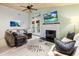Sunlit living room with a fireplace, hardwood floors, and stylish decor at 1145 Bellwood Rd, Charleston, SC 29412