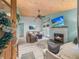 Coastal living room features a fireplace, exposed wood ceiling, ceiling fan, and access to outdoor living at 1145 Bellwood Rd, Charleston, SC 29412