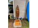 Outdoor shower with wooden surfboard and light wooden floor, next to a blue surfboard at 1145 Bellwood Rd, Charleston, SC 29412