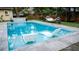 Backyard pool with clean tile surround, in-pool seating, water feature, and outdoor hammock at 1145 Bellwood Rd, Charleston, SC 29412