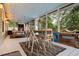 Screened-in porch with a dining table and chairs, plus a hanging daybed for a relaxing outdoor space at 1145 Bellwood Rd, Charleston, SC 29412