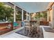 Screened-in porch featuring wooden dining table, chairs, and decorations, offering a relaxing outdoor dining area at 1145 Bellwood Rd, Charleston, SC 29412