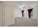 Spacious bedroom features soft carpet, ceiling fan, and two bright windows at 115 Golfview Ln, Summerville, SC 29485