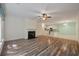 Open-concept room with fireplace, view into kitchen area and new hardwood flooring at 115 Golfview Ln, Summerville, SC 29485