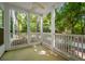 Relaxing screened porch with white columns provides a peaceful outdoor retreat at 115 Golfview Ln, Summerville, SC 29485