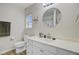 Bright bathroom featuring a large round mirror, and white vanity with modern fixtures at 117 Macy Cir, Goose Creek, SC 29445