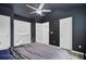 Stylish bedroom boasts a moody aesthetic with dark walls, modern decor, and comfortable furnishings at 117 Macy Cir, Goose Creek, SC 29445