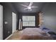 A modern main bedroom featuring dark gray walls, wood accents, and bright natural light from large windows at 117 Macy Cir, Goose Creek, SC 29445