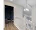 Upstairs hallway view of a bedroom and stairs with a chandelier at 117 Macy Cir, Goose Creek, SC 29445