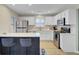 Well-lit kitchen with stainless steel appliances, white cabinetry, and a kitchen island with barstool seating at 117 Macy Cir, Goose Creek, SC 29445