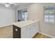 Kitchen island with white countertops, dark cabinets, and view to backyard at 117 Macy Cir, Goose Creek, SC 29445