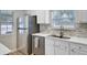 Close-up of kitchen with stainless steel refrigerator, undermount sink, and mosaic backsplash at 117 Macy Cir, Goose Creek, SC 29445